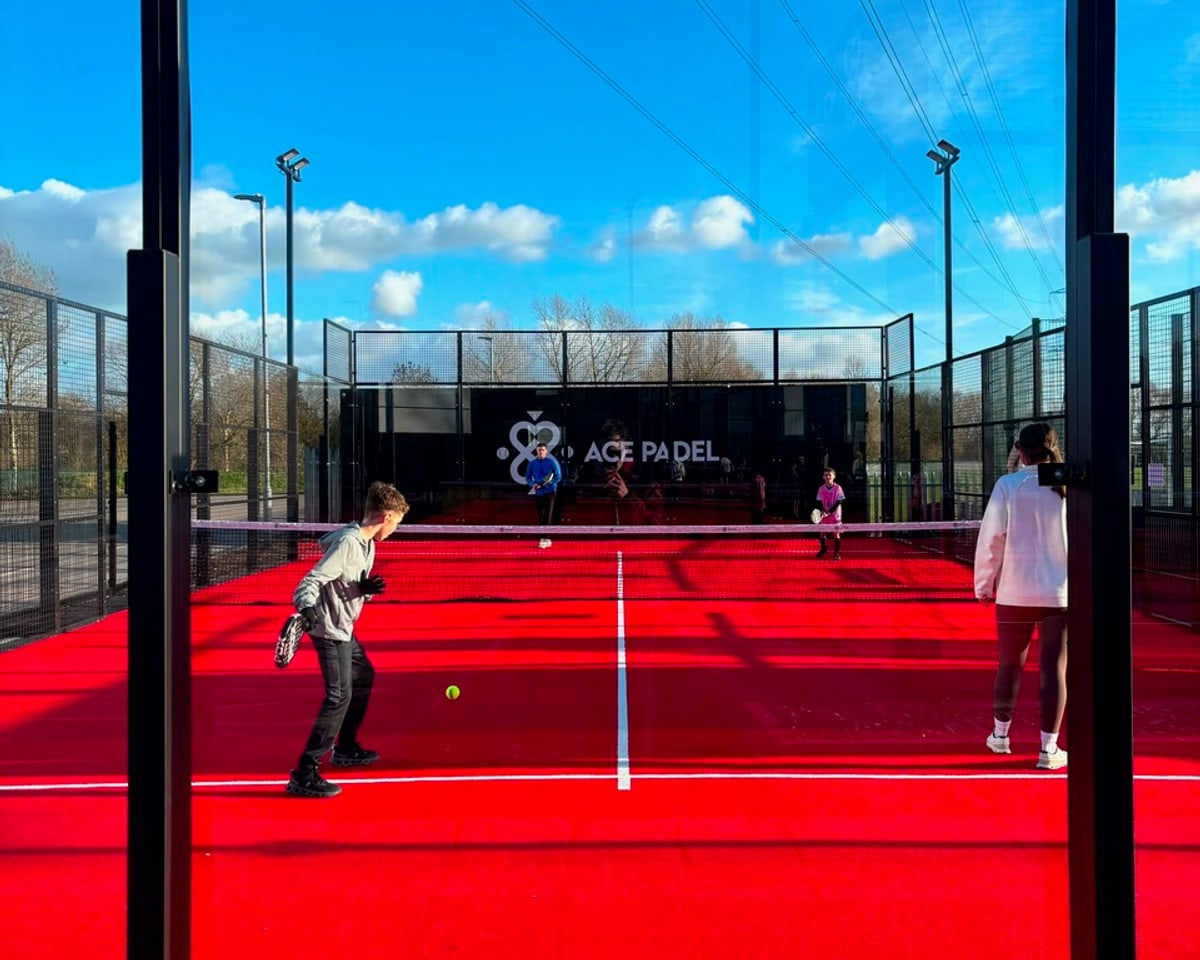 Players of all ages sharing a padel court on a bright afternoon